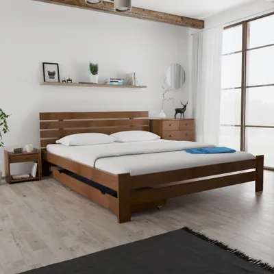 A bedroom scene with a wooden bed frame and nightstand.