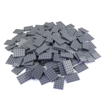 A pile of dark gray LEGO-like baseplates on a white background.
