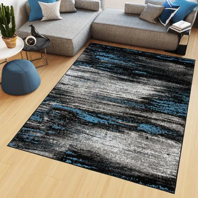 A modern living room with a sectional sofa, a rug, and decorative items.