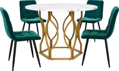 A white marble-top dining table with a gold geometric base and four dark green velvet chairs.