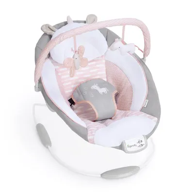 A baby bouncer seat with toys hanging from an arch.