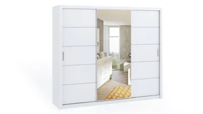 A white sliding door wardrobe with mirrored doors, reflecting a bedroom interior.