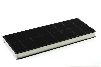 A close-up product shot of a rectangular charcoal filter with a white core and a grid-patterned black surface, against a plain white background.