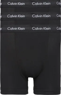 A stack of three black Calvin Klein boxer briefs, with the brand name visible on the elastic waistband of each.