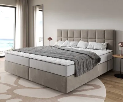 A bedroom scene with a large bed.