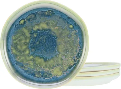 A stack of dessert plates with a unique blue and green glaze.