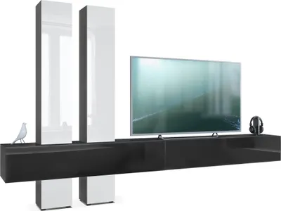 A modern black and white entertainment unit with a television and decorative items.