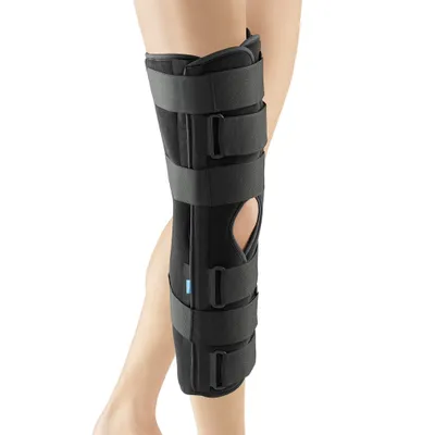 A person's leg wearing a black knee brace.