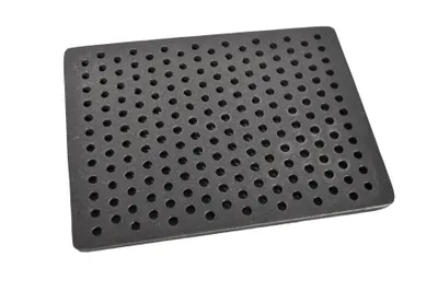 A black grate with many small holes is shown on a white background.