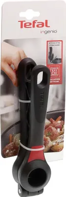 A pair of kitchen tongs in their packaging, with a hand holding them.