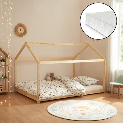 A child's bedroom with a wooden house bed, mattress, bedding, and a rug.