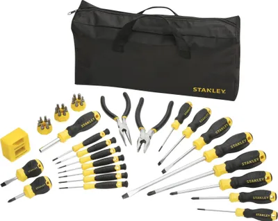 A collection of Stanley brand tools laid out on a white background, with a black tool bag in the background.