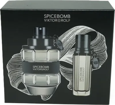 A gift set of Viktor & Rolf Spicebomb fragrances, featuring a large bottle and a smaller travel-sized bottle, presented on a black box with a white abstract design.