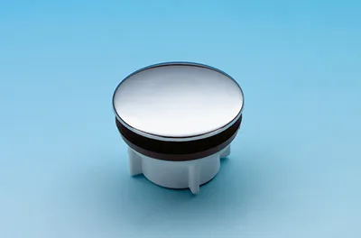 A chrome-plated drain stopper with a black rubber seal and a white plastic base is shown against a light blue background.