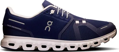 A side view of a blue and white running shoe against a white background.