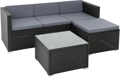 A black rattan lounge set with gray cushions and a glass-top coffee table, shown on a white background.