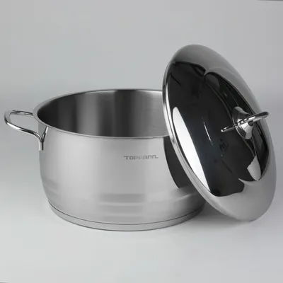 A stainless steel pot with its lid slightly ajar, set against a plain background.