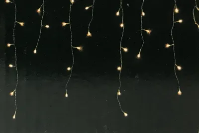 A string of warm white LED lights hanging against a black background.