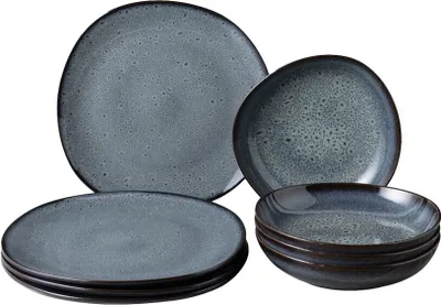 A set of stoneware plates and bowls with a speckled gray and blue glaze.