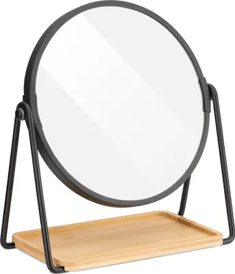 A black metal framed round mirror with a wooden tray base, shown on a white background.