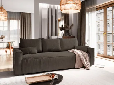 A modern living room with a brown sofa, a coffee table, and large windows.