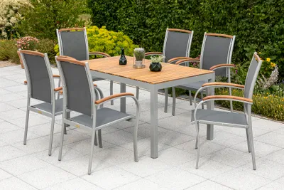 An outdoor dining set with a table and chairs on a patio.