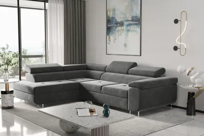 A modern living room with a large sectional sofa, coffee table, and artwork.