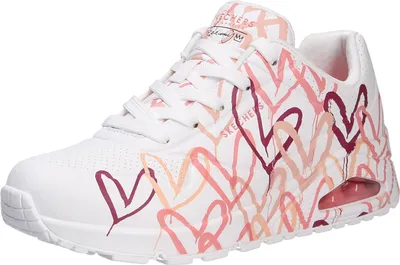 A white sneaker with a pink and red heart print.