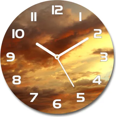 A round clock with a sunrise sky background and white numbers and hands.