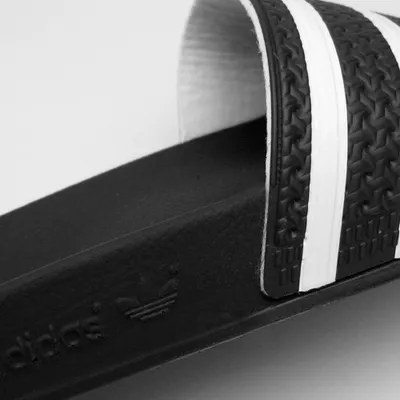 A close-up shot of an Adidas slide sandal.