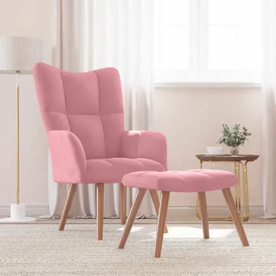 A pink velvet armchair and ottoman are placed on a rug in a room with sheer curtains and a floor lamp.