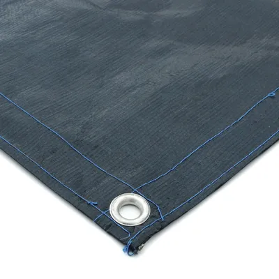 A close-up corner of a dark gray tarp with blue stitching and a metal grommet.