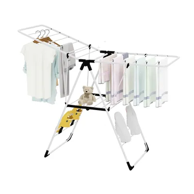A white drying rack with clothes and a teddy bear on it, against a white background.