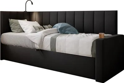 A black upholstered bed with pillows and a duvet.