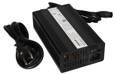 A black e-bike battery charger with cables.
