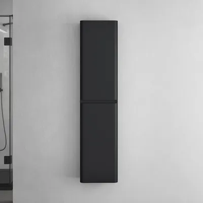 A tall, slender, black cabinet mounted on a textured white wall, with a sliver of a glass shower enclosure visible on the left.
