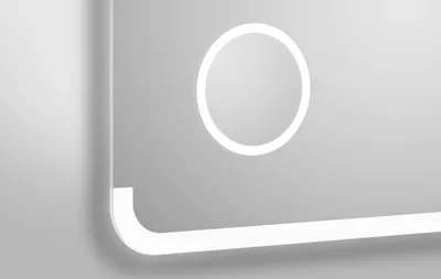A close-up, angled view of a modern bathroom mirror with integrated LED lighting.