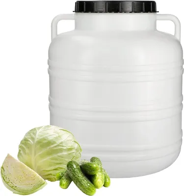 A white storage container with a black lid, next to a head of cabbage and some cucumbers.