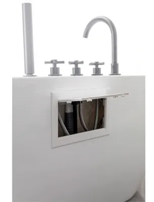 A white bathtub with chrome fixtures and an open access panel showing plumbing.