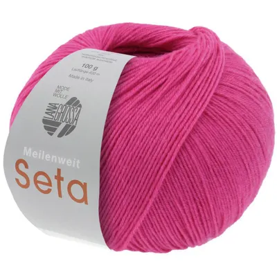 A ball of pink yarn with a label attached.