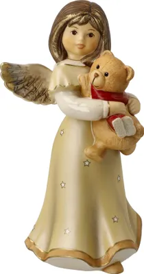 A ceramic figurine of an angel holding a teddy bear.
