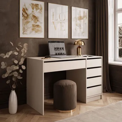 A modern desk setup with a laptop, lamp, and artwork on a dark wall.