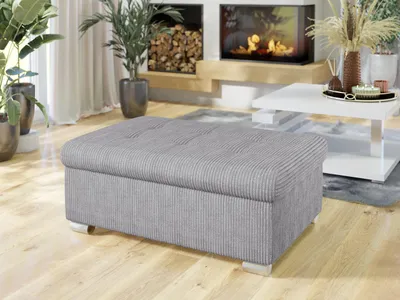 A modern living room with a fireplace, plants, and furniture.