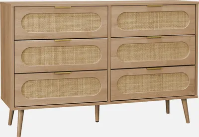 A front view of a wooden dresser with rattan drawer fronts.