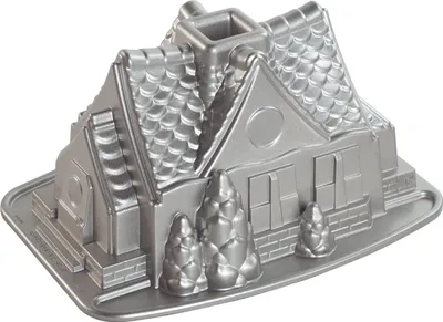 A silver-colored metal bundt pan shaped like a gingerbread house.
