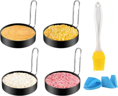 A set of four round metal molds filled with different food items, along with a silicone brush and two small blue silicone holders, arranged on a white background.