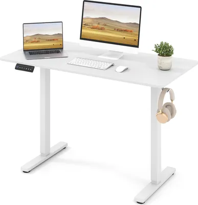 A white adjustable standing desk with a laptop, monitor, keyboard, mouse, and headphones.
