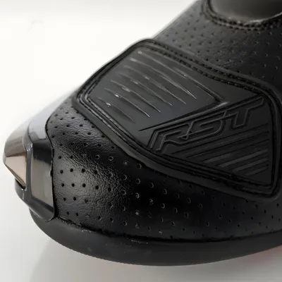 Close-up of the toe area of a black motorcycle boot.
