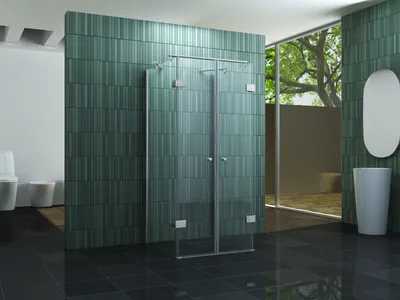 A modern bathroom with a glass shower enclosure, green tiled walls, a sink, and a toilet.