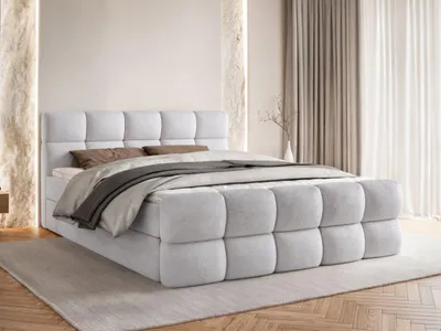 A bedroom setting with a bed.